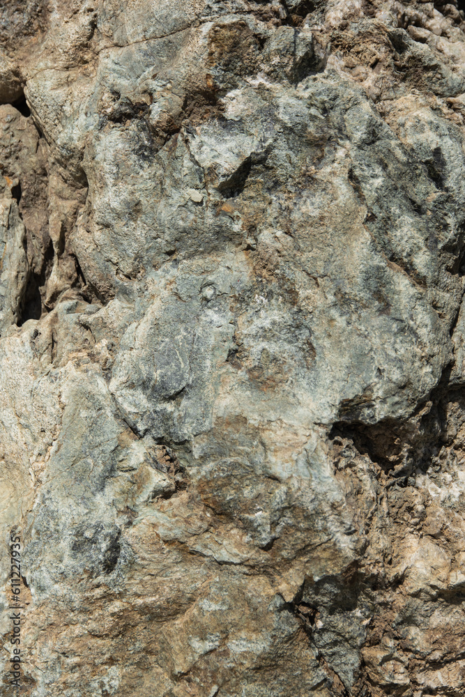 Texture of natural yellow textured stone in sunlight