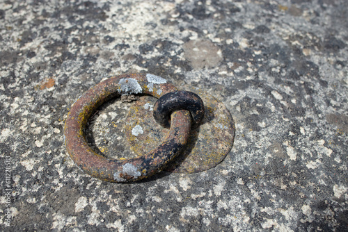 Heavy metal ring handle fixed in old and weathered concrete