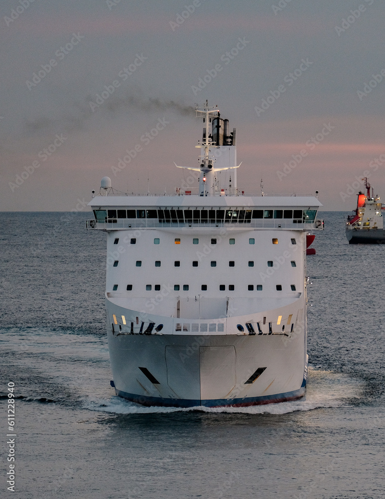 Passenger pax cargo car roro ro-ro ferry boat vessel cruiseship cruise ship  liner at sea with sky and coastline Photos | Adobe Stock