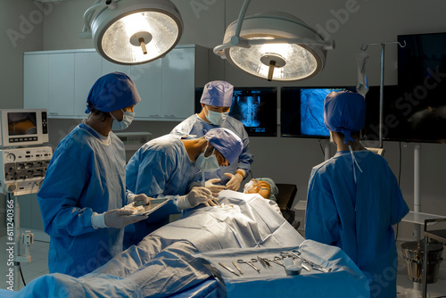 Teamwork of surgeon preparing for surgery in operating room