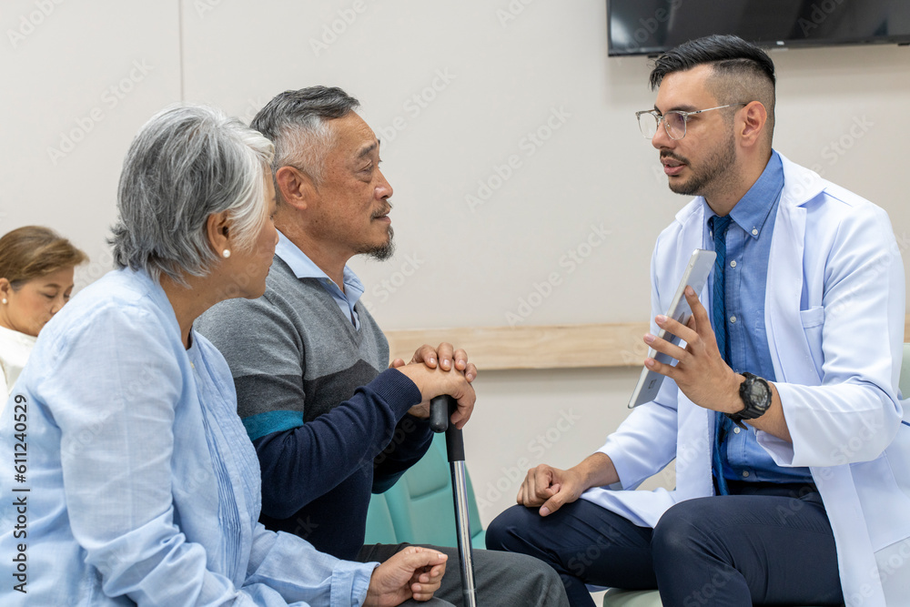 Obraz premium Mature couple listening recommendation from young doctor in hospital