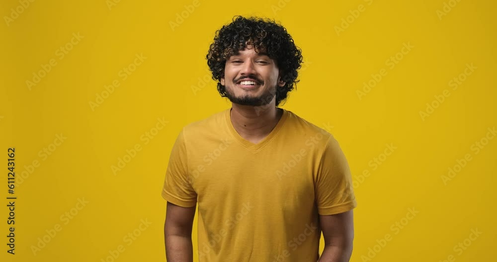 Charismatic handsome indian man touch temple and pointing camera as agree with friend, praise good thought, nice suggestion, standing on orange studio background Charismatic handsome indian man touch temple and pointing camera as agree with friend, praise good thought, nice suggestion, standing on orange studio background