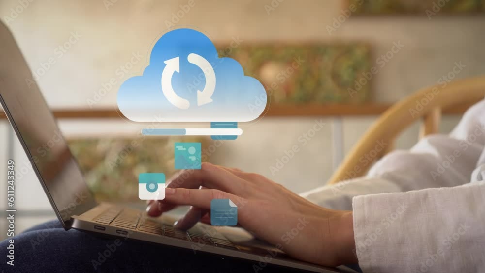Woman working on her laptop at home while data being synchronized to cloud computing online storage and IOT computer network for devices. Blockchain, Cloud storage high speed wi-fi internet connection