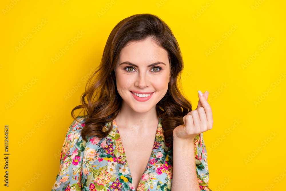 Photo of cute positive girl beaming smile arm fingers demonstrate korean love gesture isolated on yellow color background Photo of cute positive girl beaming smile arm fingers demonstrate korean love gesture isolated on yellow color background