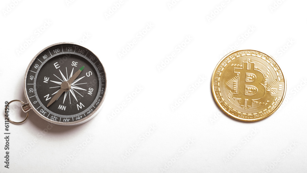 cryptocurrency, direction and money concept. bitcoin coins with a compass on a white background. place for text. E-commerce, cryptocurrency, direction and money concept. bitcoin coins with a compass on a white background. place for text. E-commerce,