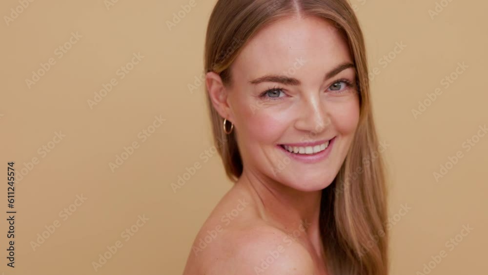 Close-up beauty portrait of young blonde-haired woman who softly looking down at her shoulder, and looks at the camera and smiles | Soft skin and skincare concept Close-up beauty portrait of young blonde-haired woman who softly looking down at her shoulder, and looks at the camera and smiles | Soft skin and skincare concept