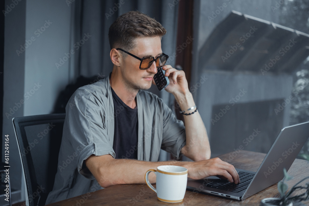 Handsome man call in smartphone, happy face, outdoor hipster portrait on the cafe, smile happy face, listen music on headphones, text, messenger, hipster, player,photo concept, laptop, coffee cup Handsome man call in smartphone, happy face, outdoor hipster portrait on the cafe, smile happy face, listen music on headphones, text, messenger, hipster, player,photo concept, laptop, coffee cup