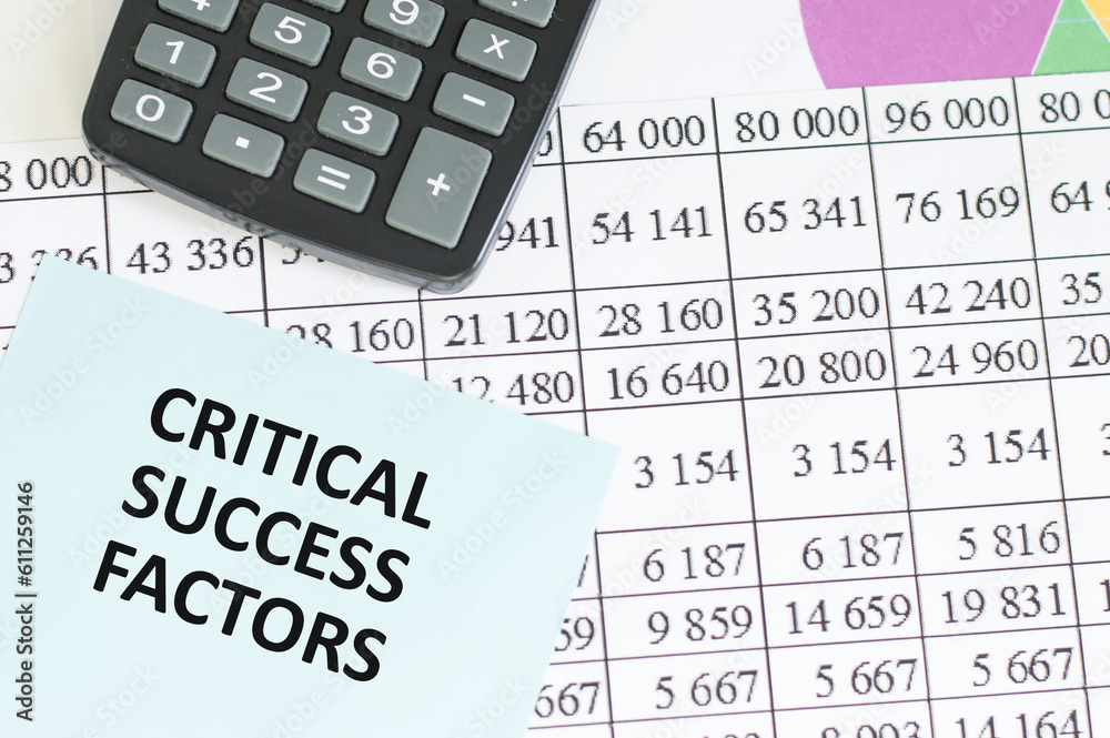 Business concept. Notebook with text CRITICAL SUCCESS FACTORS sheet of white paper for notes, calculator in the white background Business concept. Notebook with text CRITICAL SUCCESS FACTORS sheet of white paper for notes, calculator in the white background