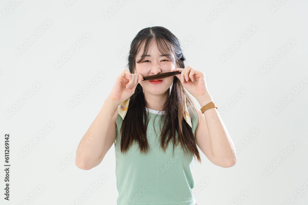 Portrait isolated cutout studio shot of Asian young cool female teenage fashion model with pigtails braids hairstyle in casual trendy shirt shorts standing posing look at camera on white background Portrait isolated cutout studio shot of Asian young cool female teenage fashion model with pigtails braids hairstyle in casual trendy shirt shorts standing posing look at camera on white background
