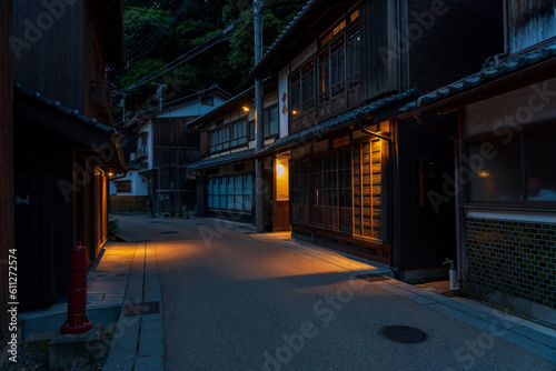 Night view of street with traditional boathouses at Ine Town in Kyoto, Japan.