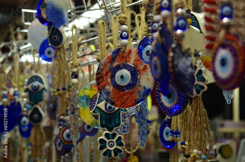 Nazar in market. Blue and red Fatima eye close-up protective amulet against evil eye. Israeli and turkish souvenir. 