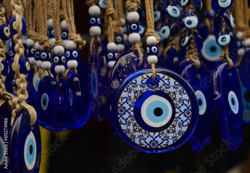 Nazar in market. Blue and red Fatima eye close-up protective amulet against evil eye. Israeli and turkish souvenir. 