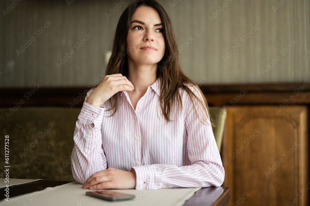 Young beautiful brunette woman sit in coffee shop cafe restaurant indoors. Young beautiful brunette woman sit in coffee shop cafe restaurant indoors.