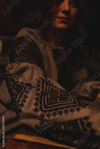 A beautiful young girl in an ethnic vyshyvanka outfit, the shirt is embroidered by hand. Ukrainian brunette with long hair