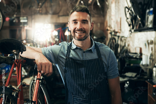 Portrait, smile and repair man in bicycle shop working in store or cycling workshop. Face, bike mechanic and confident male person, business owner or mature professional technician from Australia. © Grady Reese/peopleimages.com