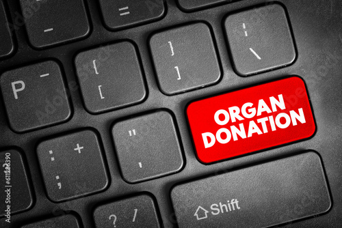 Organ donation - process of surgically removing an organ or tissue from one person and placing it into another person, text concept button on keyboard photo