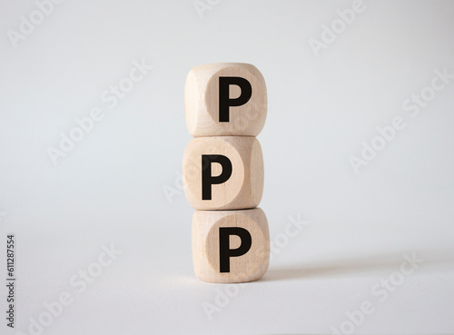 PPP private public partnership symbol. Wooden cubes with words PPP. Beautiful white background. Business and PPP concept. Copy space.