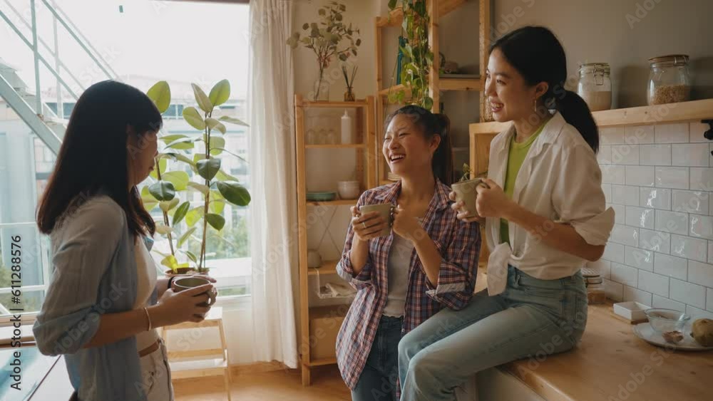 Three female friends having fun and drinking green matcha tea in the kitchen. Three female friends having fun and drinking green matcha tea in the kitchen.