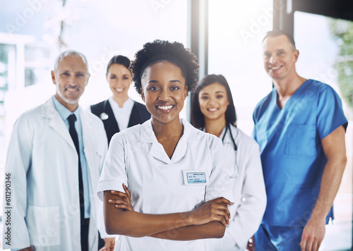 Smile, team and portrait of black woman with doctors, nurses and diversity in hospital with teamwork in healthcare. Health, support and boss, confident doctor with group of medical employees together