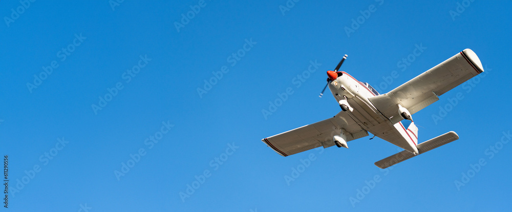 Small white cessna single propeller plane flying in a clear blue sky maneuvering before landing at Sabadell airport - obrazy, fototapety, plakaty 
