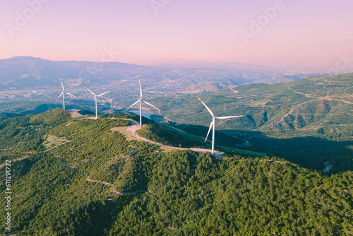 Wind turbines spinning in the wind energy station in mountain. Aerial view