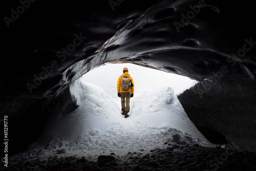  traveler finds himself detained in an impressive landscape of ice inside the Vatnajokull National Park, in Iceland. The dazzling ice formations and intricate patterns reveal the magnificent beauty o