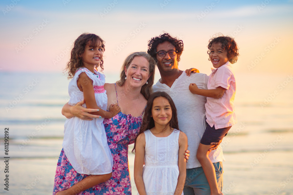 Family walking on tropical beach at sunset Family walking on tropical beach at sunset