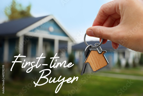 First-time buyer. Woman holding house keys outdoors, closeup photo