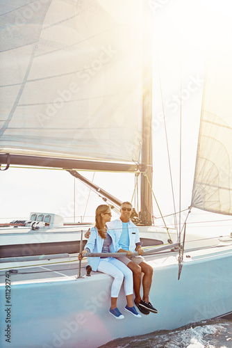 Couple, boat and adventure at sea for holiday during summer to relax on luxury or rich cruise. Ocean, vacation and people on yacht for outdoor travel and freedom to enjoy the sunshine together. © Grady Reese/peopleimages.com