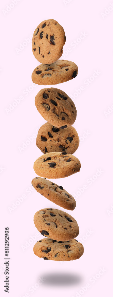 Delicious chocolate chip cookies falling on light background Delicious chocolate chip cookies falling on light background