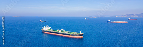 Aerial wide shot of Crude Oil Tankers ships anchorage near sea port, Export Import of Crude Oil. Wide banner