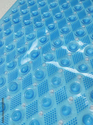 Polyvinyl chloride blue bathroom rug, close up view back side