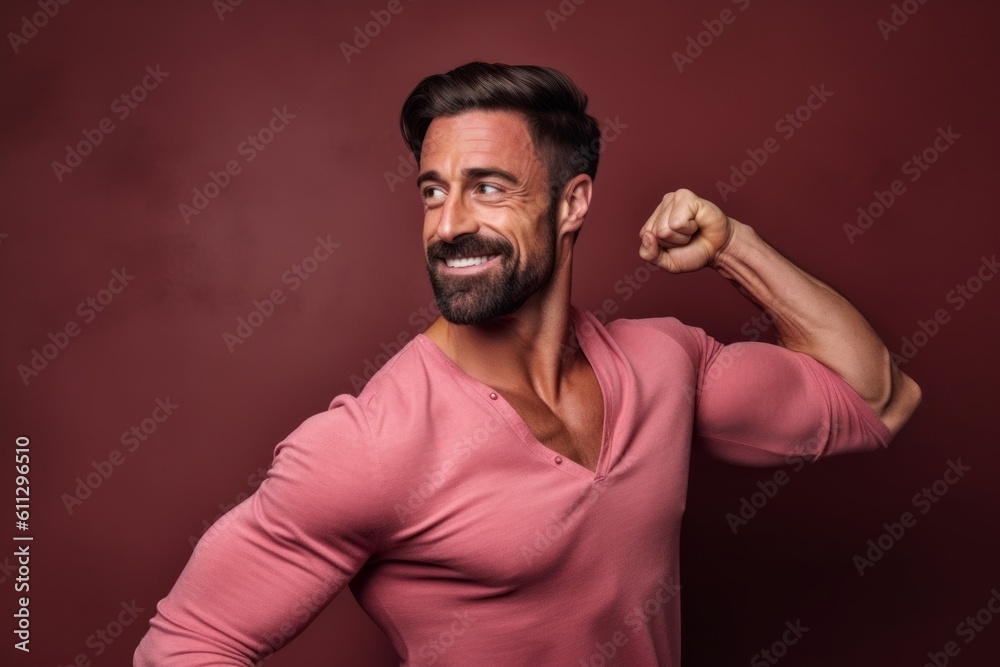 Headshot portrait photography of a beautiful boy in his 30s extending arms to one side in a gesture of freedom against a dusty rose background. With generative AI technology