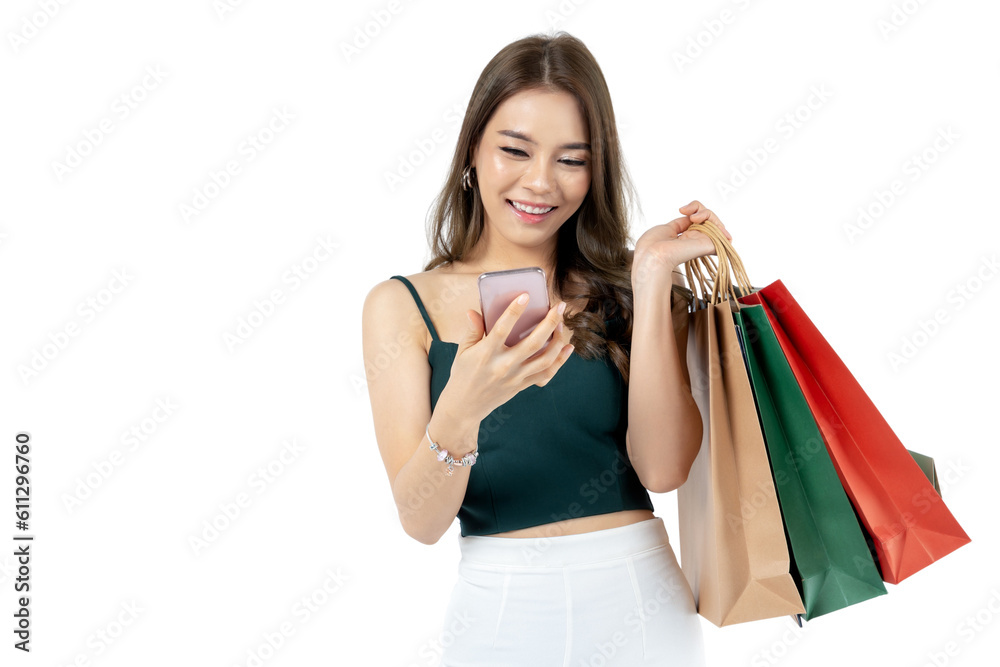 Young Asian woman using smart phone and holding shopping bag shoot in isolated white background, remove background. shopping payment concept Young Asian woman using smart phone and holding shopping bag shoot in isolated white background, remove background. shopping payment concept