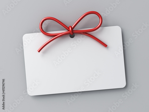 Blank gift card or white note with red rope bow isolated on white grey background with shadow minimal conceptual 3D rendering