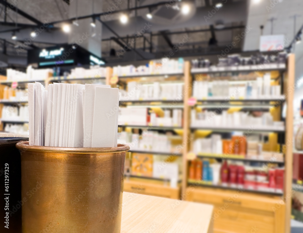 Obraz premium buying make up at cosmetics section in store. choosing cosmetics, perfumes, creams and shampoos, Using tester.