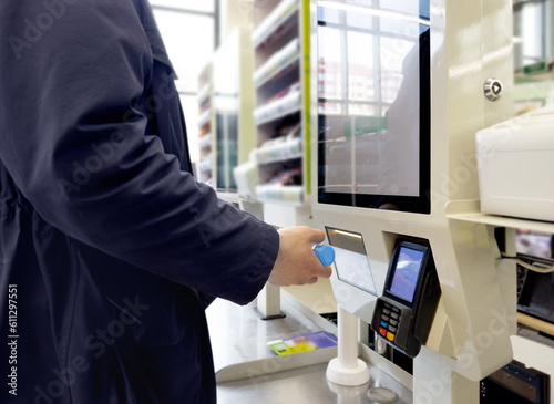 Wallpaper Mural Customer pays his purchase at the supermarket,self checkout systems in  retail stores,Barcode scanner,Self checkout machine Torontodigital.ca