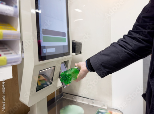 Customer pays his purchase at the supermarket,self checkout systems in retail stores,Barcode scanner,Self checkout machine