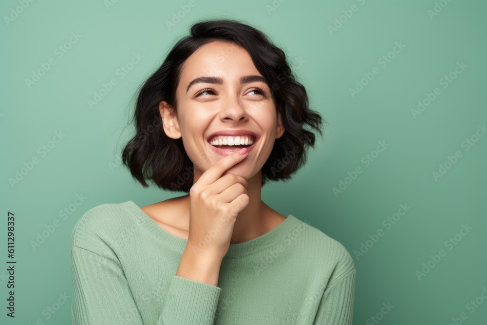 Headshot portrait photography of a satisfied girl in her 30s placing the hand over the mouth in a laughter gesture against a pastel green background. With generative AI technology Headshot portrait photography of a satisfied girl in her 30s placing the hand over the mouth in a laughter gesture against a pastel green background. With generative AI technology