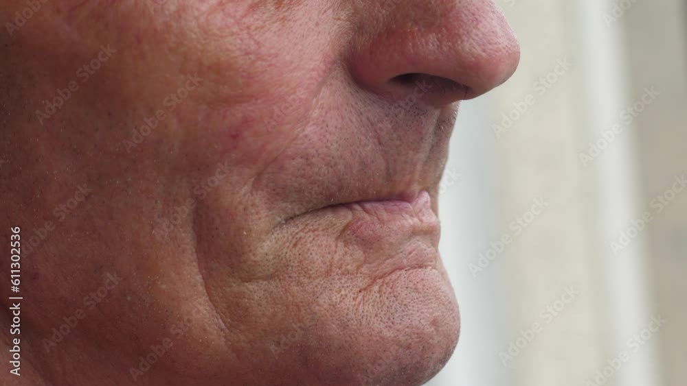 close-up of the face of a grandfather smoking a cigarette and blowing smoke. an elderly man is addicted to smoking. an old man meditates while smoking a cigarette close-up of the face of a grandfather smoking a cigarette and blowing smoke. an elderly man is addicted to smoking. an old man meditates while smoking a cigarette