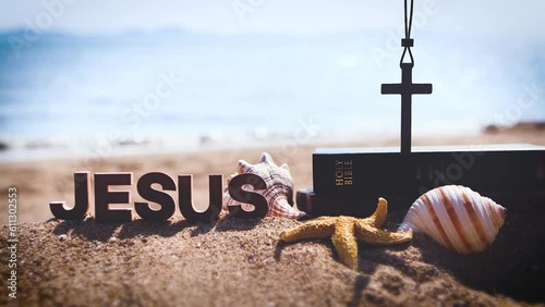 Bible book and cross of Jesus Christ on sea sand beach and church summer retreat and summer bible school summer camp
