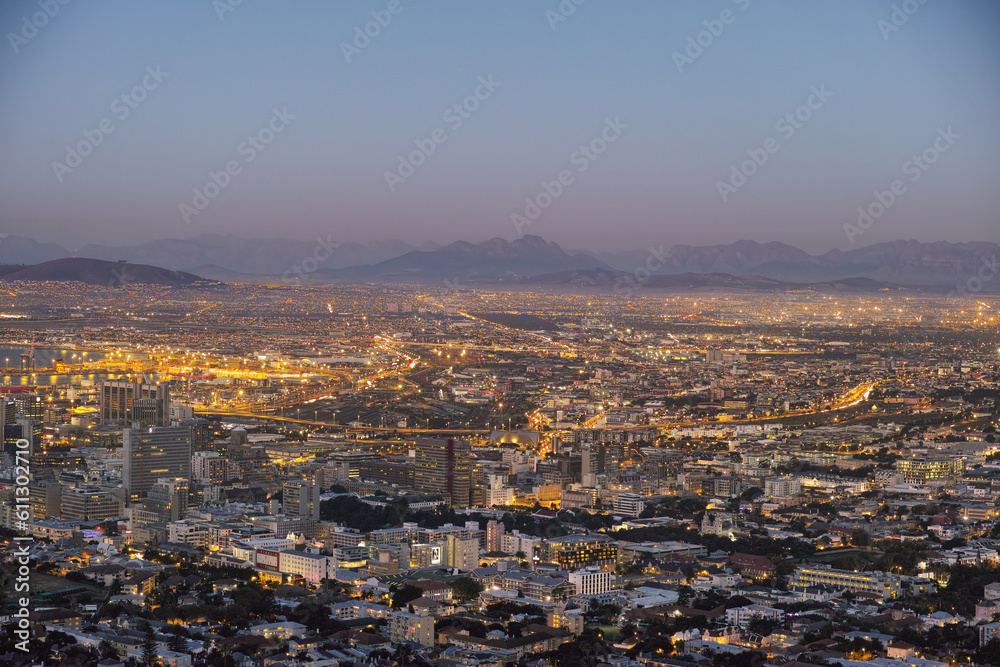 Night, cityscape and urban buildings, architecture or infrastructure for development, expansion and property. Skyline, cbd and mountains with city skyscraper, commercial road or space in Cape Town