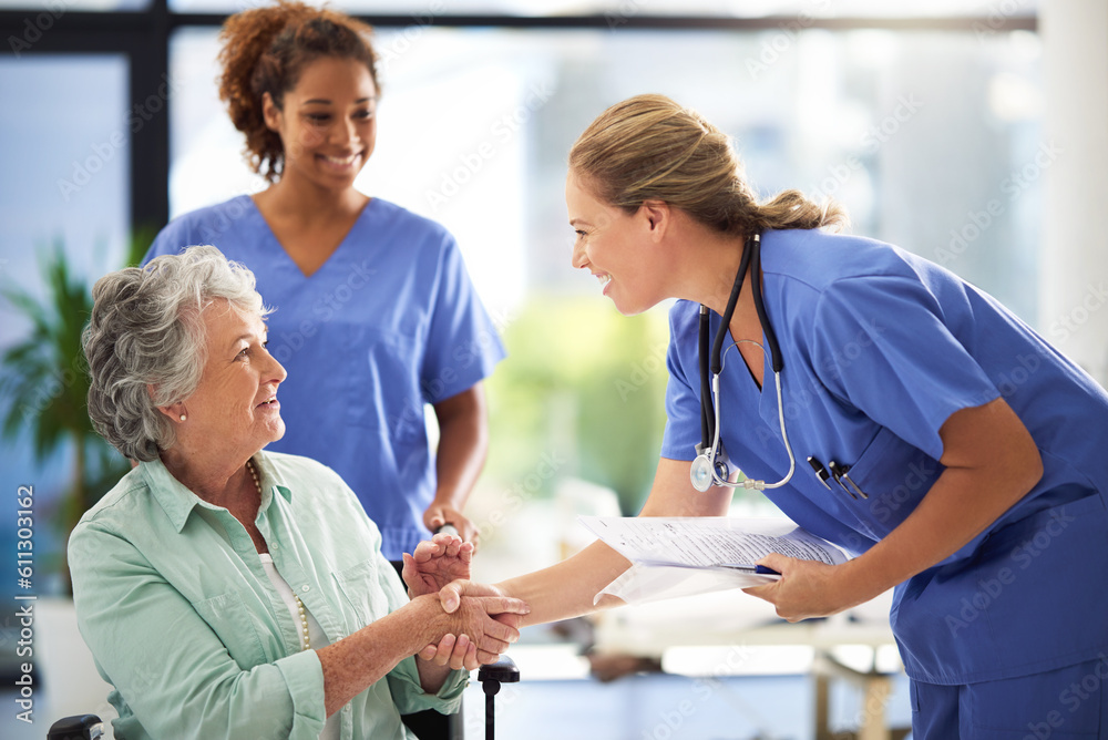 Obraz premium Handshake, nurse and senior woman in wheelchair with medical results and surgery success news. Hospital, healthcare and clinic with women and nursing staff with care and support of elderly person