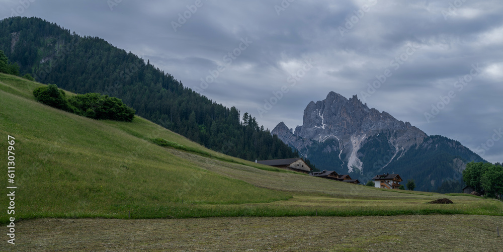 Stunning scenery. Natural background with dramatic sky. A village in a valley against the backdrop of majestic mountains in Trentino Alto Adige, Italy, Europe.