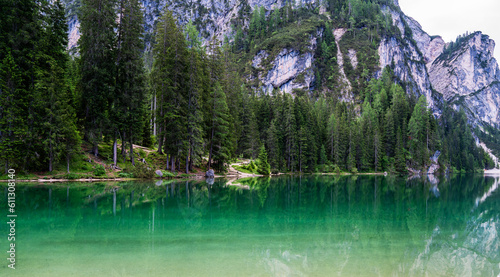 Mountain blue lake water landscape. Braies lake with crystal water in background of mountains. Dolomites, Italy.