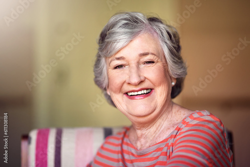 Portrait, nursing home and happy senior woman in living room, laughing in house or relax in retirement. Elderly lady, happiness and healthy person laughing at funny, joke or freedom of retired life