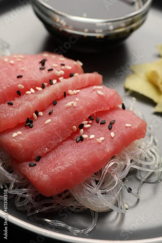 Tasty sashimi (pieces of fresh raw tuna) and glass noodles on plate, closeup