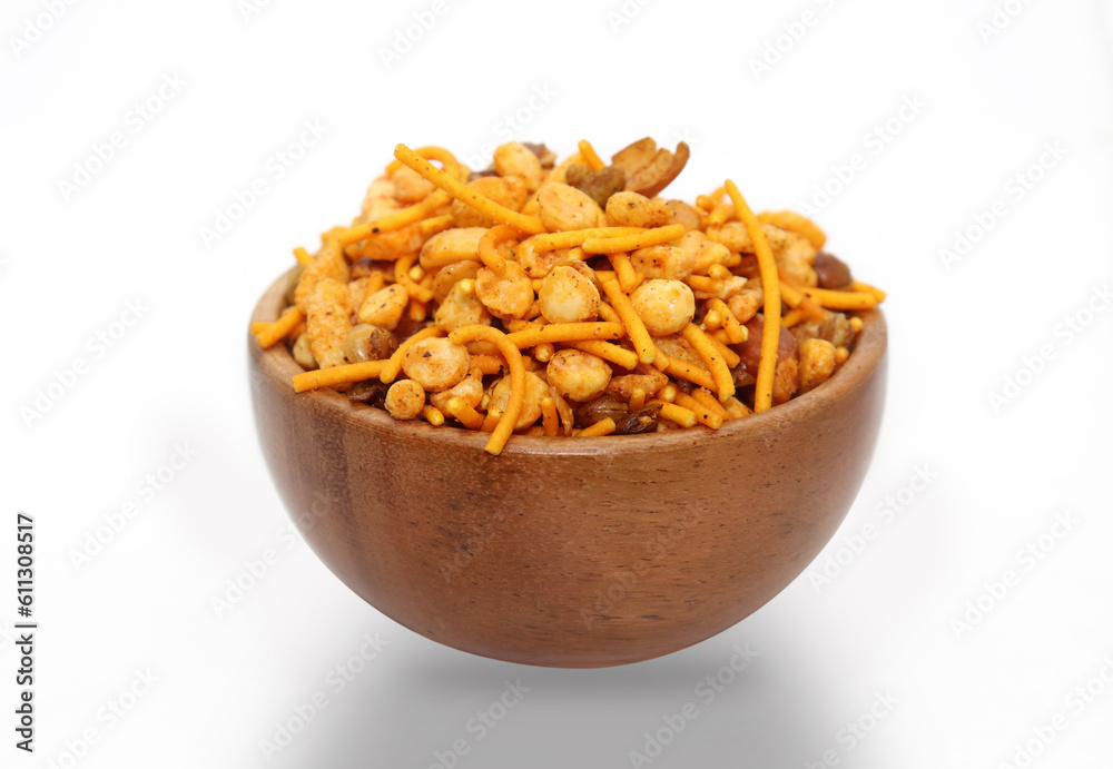 Hot spicy NavRatan snacks in wooden bowl, made with, potato chips, peanuts, besan sev, red chili. Hot spicy NavRatan snacks in wooden bowl, made with, potato chips, peanuts, besan sev, red chili.