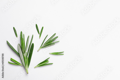 Sprigs of fresh rosemary on white background, flat lay. Space for text