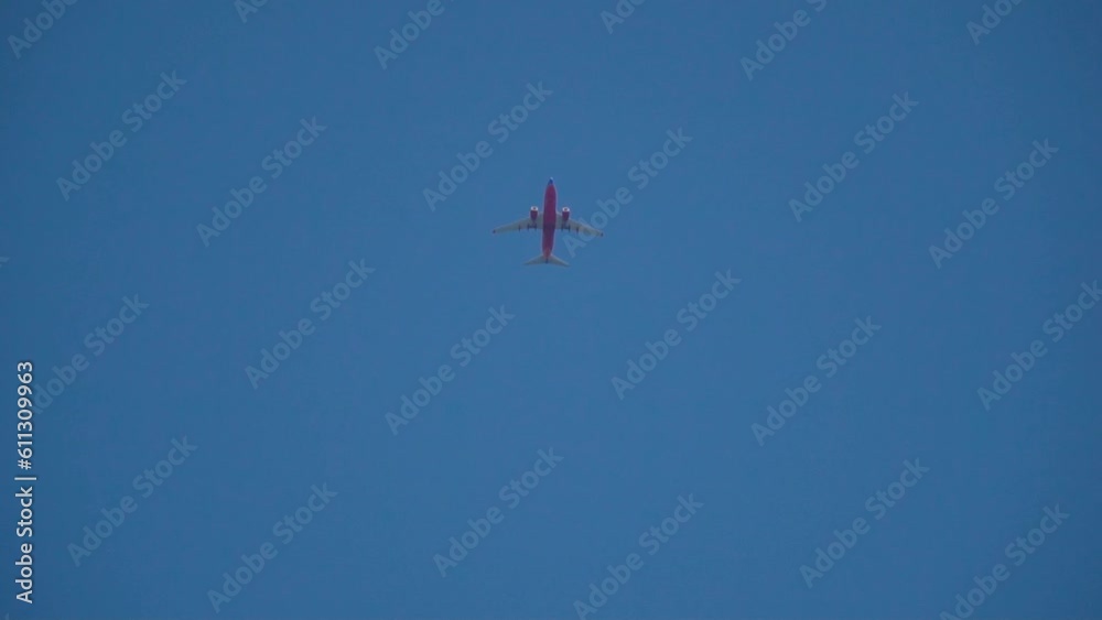 Airplane flight over skyscrapers business center. Bottom view of a flying plane on a bright sunny day. Airplane flight over skyscrapers business center. Bottom view of a flying plane on a bright sunny day.
